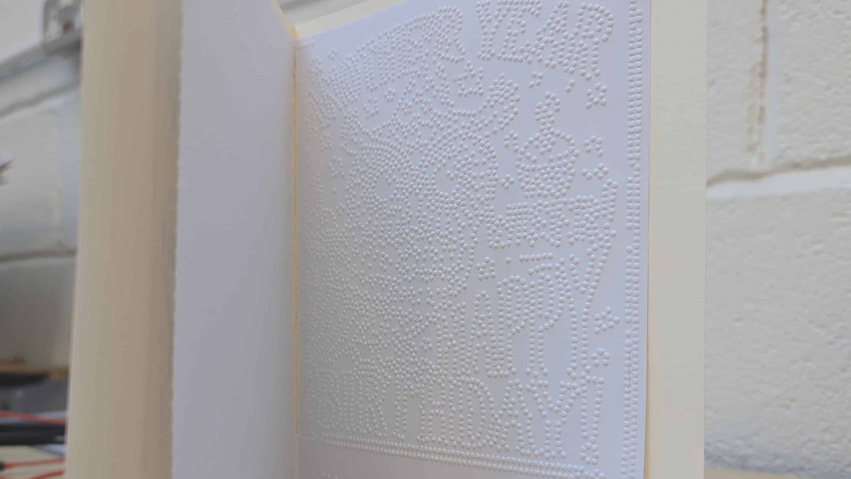 A close up photo of the braille inside our braille cards